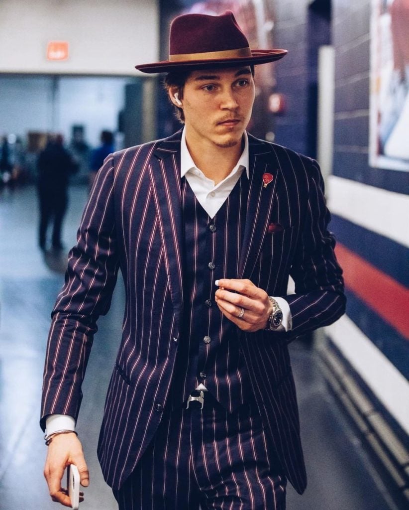 NHL's fashion Elvis Merzlikins of the Columbus Blue Jackets wearing three-piece pinstripe suit and fedora