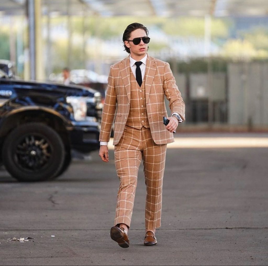 Troy Stecher Arizona Coyotes shows off NHL fashion in tan windowpane suit, black tie, and black sunglasses